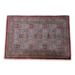 Iranian silk rug. Colours: white, red, black and green.