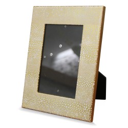 Gold lacquered photo frame with white pebble design.