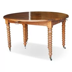 Drop-leaf table in walnut, turned legs with casters, 4 extensions.