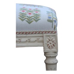 A richly carved Louis XVI bench, painted wood. Upholstered in floral lampas fabric.