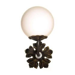 Patinated brass wall light with opaque glass globe …
