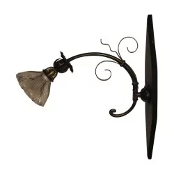 wrought iron wall lamp with glass and wooden support. Era …