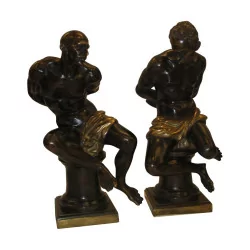 Paire de bronzes “Esclaves Noirs” en bronze patiné.