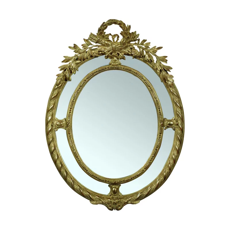 Miroir ovale de style Louis XVI en bois sculpté et doré. - Moinat - Glaces, Miroirs