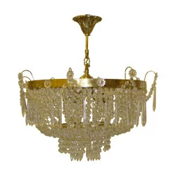 gilded bronze chandelier with drop-shaped crystals.