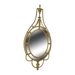 George III oval mirror in carved and gilded wood.