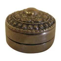 Round silver pill box with decoration on the lid. …