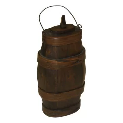 Small oval liquor barrel in wood and a metal handle. …