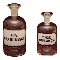 Pair of glass pharmacy bottles with caps with …