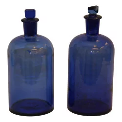 Pair of blue glass pharmacy bottles with …