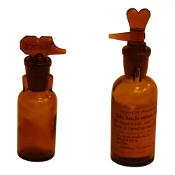 Pair of burnished glass pharmacy bottles with caps …