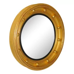 Regency “Eagle” mirror in round gilded wood.