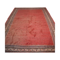 Tapis avec bordure et fond rouge au centre.