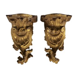 Pair of carved and gilded wooden wall consoles with decoration