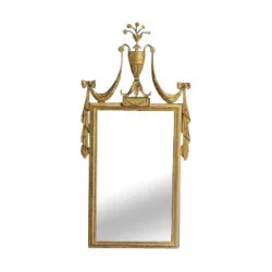 Golden mirror with cup and drapes.