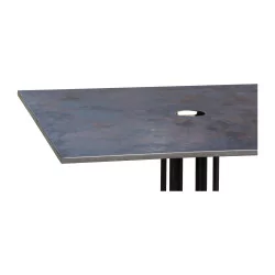 Raw metal table with bistro-style metal top.