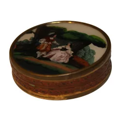 Round keepsake box with a romantic scene on top. Dated…