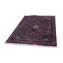 Oriental rug in red with fringe. 20th century