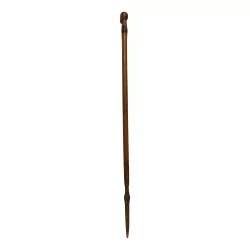 wooden cane with the head of a black man and the end with a spike...