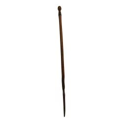 wooden cane with the head of a black man and the end with a spike...