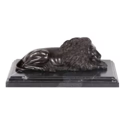 Statuette of a burnished bronze lion on a marble base (right).