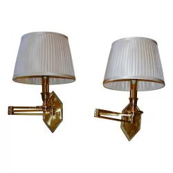 Articulated brass wall lamp with white pleated lampshade.