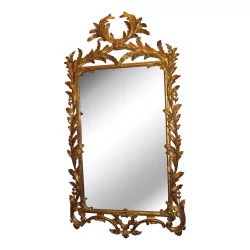 Carved and gilded wooden mirror.