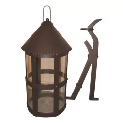 round lantern with rust-coloured aluminum stem.