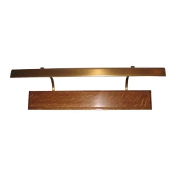 Patinated brass finish reflector, with wooden support.