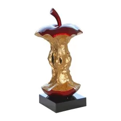 red and gold apple core on a black base.