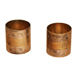 Pair of napkin rings in silvered brass, richly …