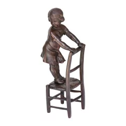 Bronze \"Little girl in chair\" reproduction.