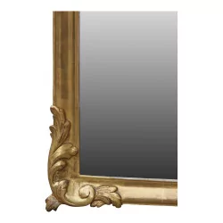 Large mirror with gilded wooden frame, pediment decorated with flowers...