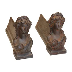 Pair of andirons with faces of women in cast iron. 20th …