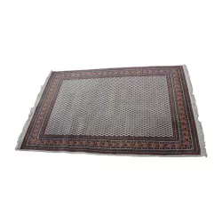 Oriental rug in black, blue, red, yellow with fringe