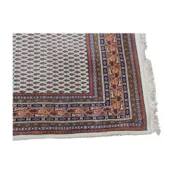 Oriental rug in black, blue, red, yellow with fringe
