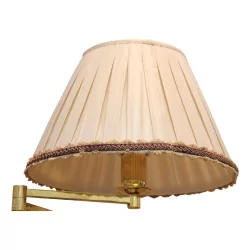 Articulated floor lamp in gilded brass with lampshade.
