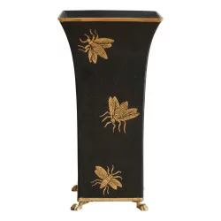 Black vase with golden bees.