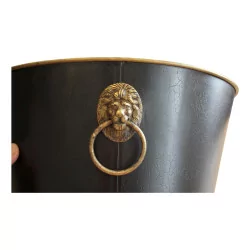 Cache-pot in black sheet metal with golden handles.