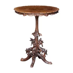 Round table on tripod foot, in carved wood from Brienz in …
