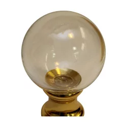 Smooth glass stair ball with golden base.