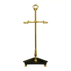 Golden umbrella stand with black base.