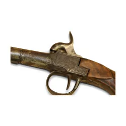 Pistol with carved wooden butt and guilloché breech.