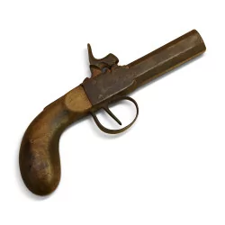 Pistol with wooden stock and steel barrel.