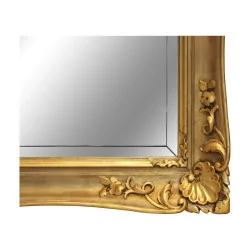 Miroir Régence avec cadre en bois doré et glace biseautée.