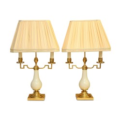 Paar „JANSEN“-Lampen aus Messing und weißem Porzellan.