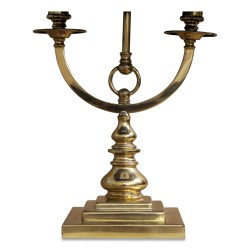 A brass hot water bottle lamp with a purple shade. France