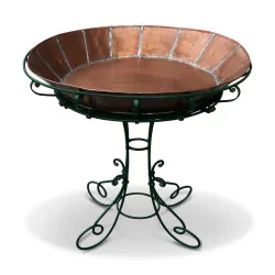 Green lacquered wrought iron planter with a copper tray.