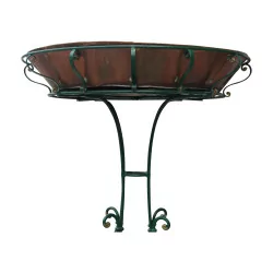 Green lacquered wrought iron planter with a copper tray.