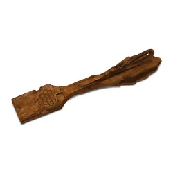 wooden clip carved in the shape of a leaf and decorated with a …